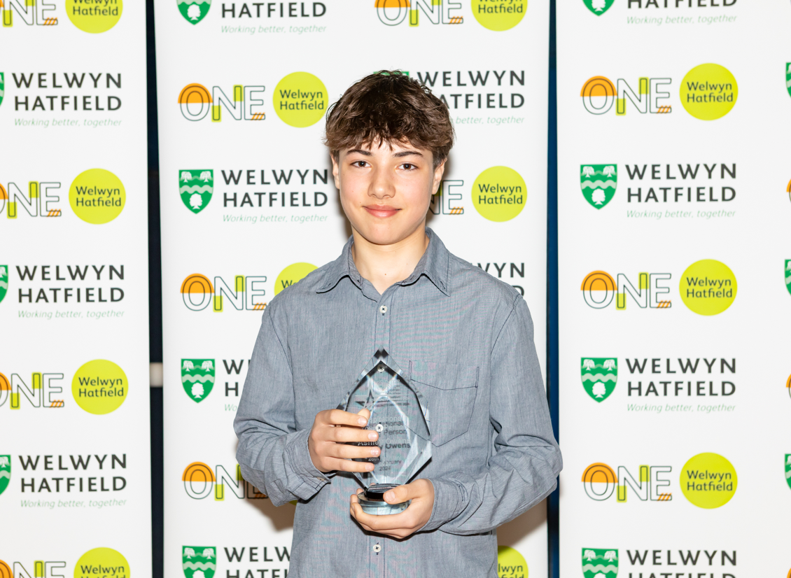 young boy with award
